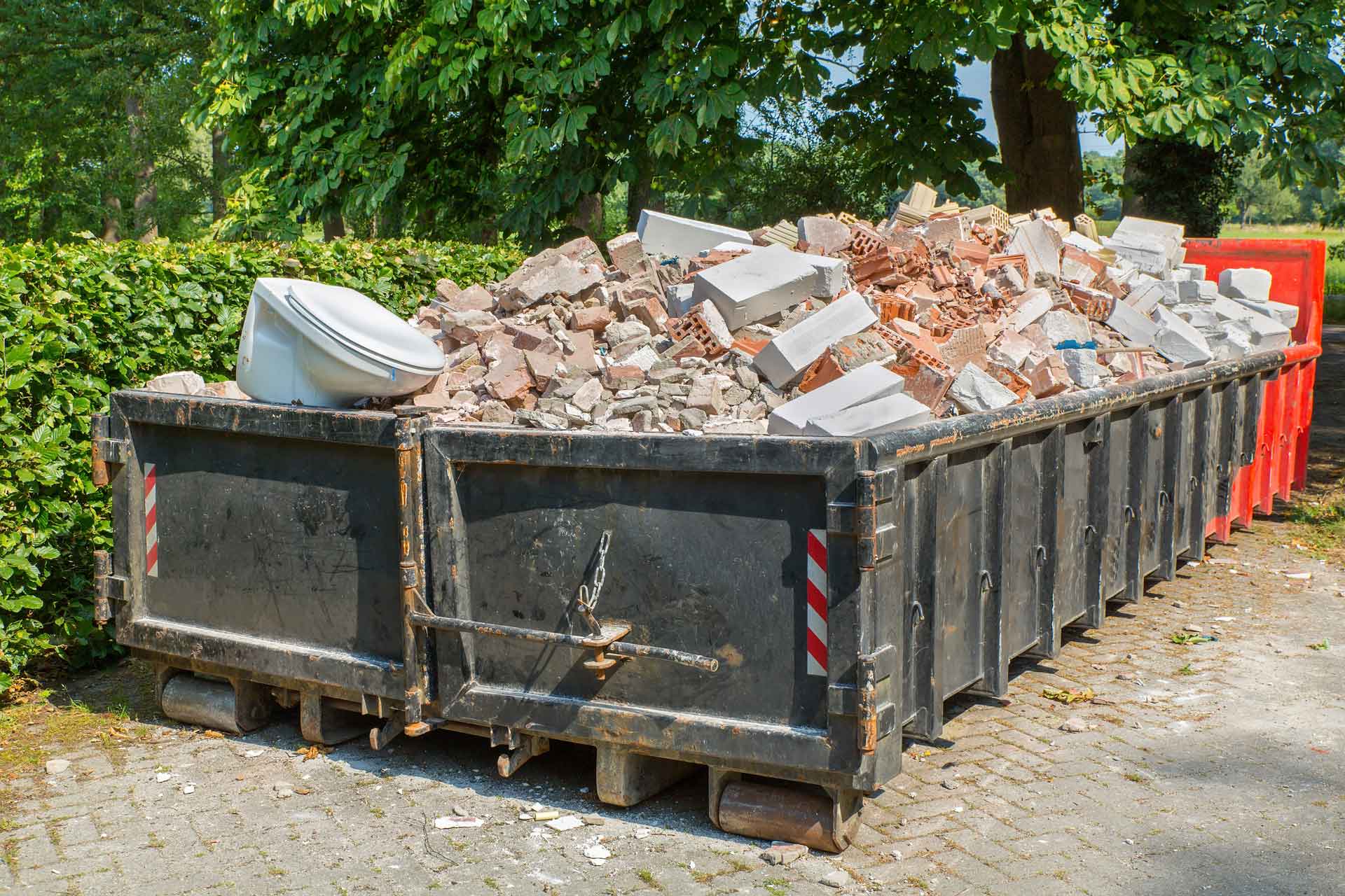 Rental dumpster full of bricks and cinderblocks