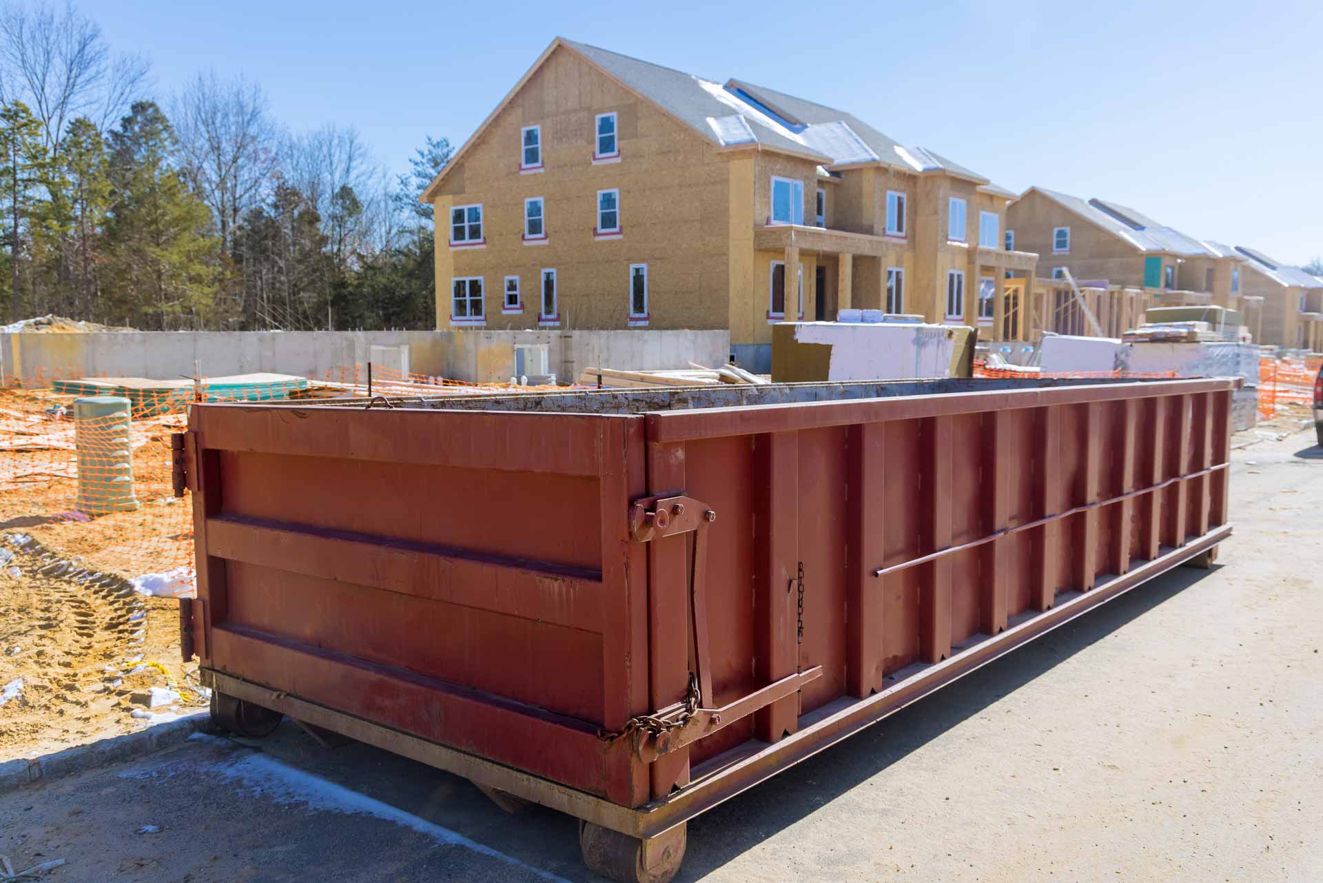 Red rental dumpster on construction site